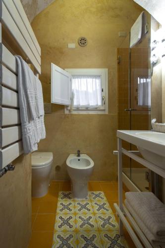 a bathroom with a toilet and a sink at Le Dimore Dell' Idris in Matera