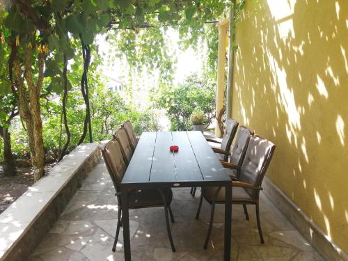 a table and chairs sitting on a patio at MORE Podgora Luxury Design Apartment in Podgora