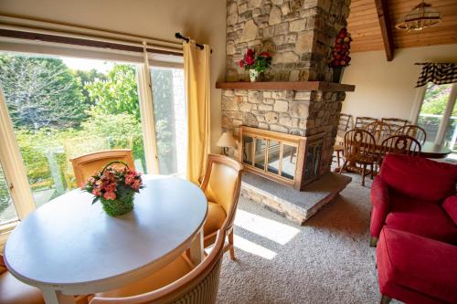 a living room with a table and a fireplace at Coachlite Inn in Sister Bay