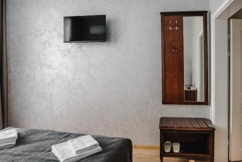 a bedroom with a bed and a mirror and a cabinet at Чевермето-Ірен in Luts'k