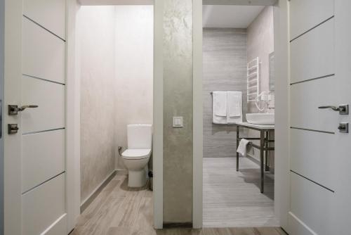 a bathroom with a toilet and a sink at Чевермето-Ірен in Luts'k