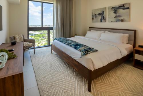 a bedroom with a bed and a desk and a window at Provident Grand Luxury Short-Term Residences in Miami