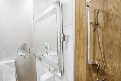 a bathroom with a shower and a sink and a mirror at Чевермето-Ірен in Luts'k