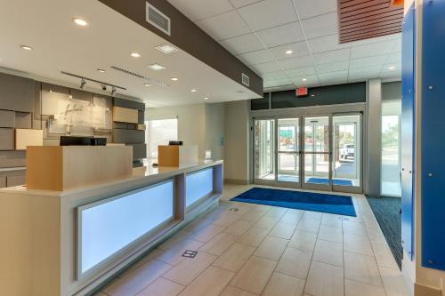 an office with a lobby with a reception counter and glass doors at Holiday Inn Express & Suites - Roanoke – Civic Center in Roanoke