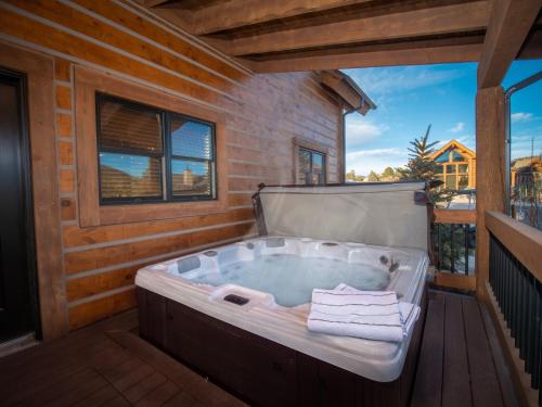 a jacuzzi tub on the deck of a house at Beautiful Views! Jacuzzi, Indoor/ Outdoor Fireplace, Steps to Lake Estes in Estes Park