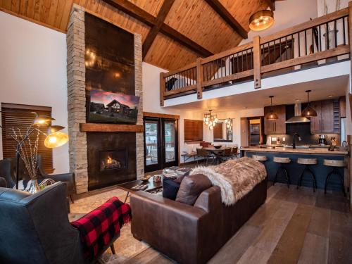 a living room with a couch and a fireplace at Rocky Mountain Escape - Steps to Lake Estes, Jacuzzi, Close to Downtown Estes in Estes Park