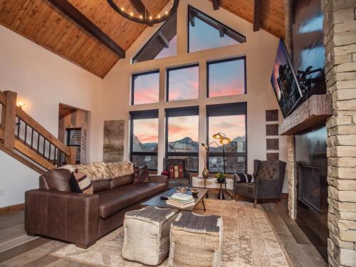 a living room with a couch and a table at Rocky Mountain Escape - Steps to Lake Estes, Jacuzzi, Close to Downtown Estes in Estes Park