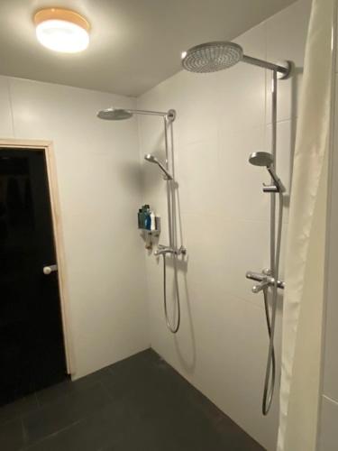 a bathroom with two shower systems on a wall at Guesthouse Kärsämäki in Kärsämäki