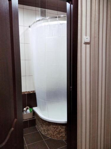 a bathroom with a tub with a glass shower at центр вулиця Миру in Shostka