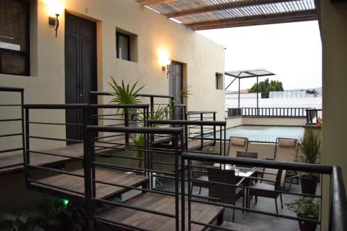 a balcony with chairs and plants on a building at Independencia Dos 7 Hotel Boutique in Querétaro
