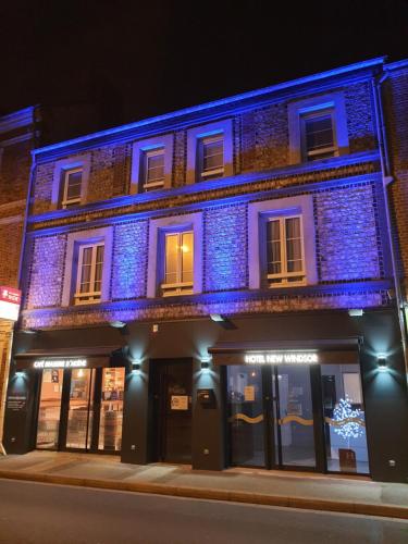 a building with blue lights on the side of it at New Windsor in Étretat