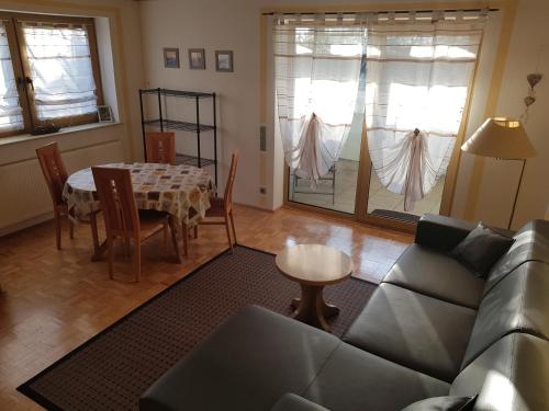 a living room with a couch and a table at Apartment am Riegelberg in Oesdorf