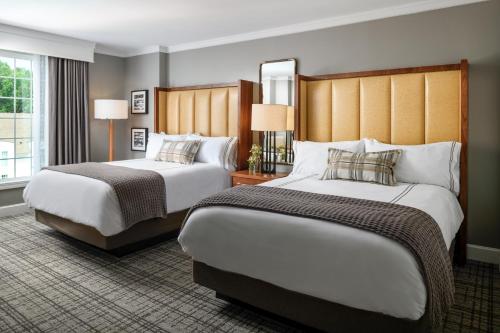 a hotel room with two beds and two lamps at Chateau Elan Winery in Braselton