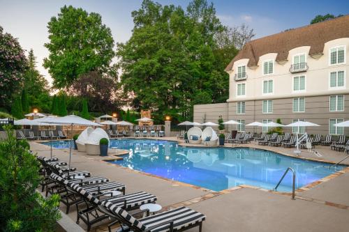 a pool at a hotel with chairs and umbrellas at Chateau Elan Winery in Braselton