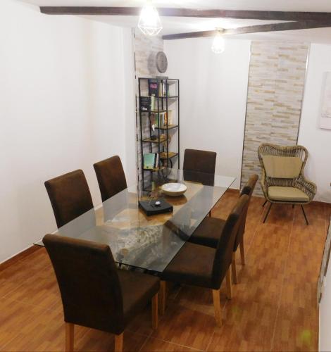 a dining room with a glass table and chairs at Chabela's Suites in La Lajita