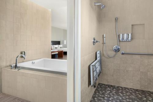 a bathroom with a tub and a shower at Hotel Casa 425 + Lounge, A Four Sisters Inn in Claremont
