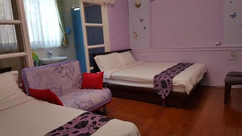a room with two beds and a couch and a chair at Dongshan River Left Bank in Wujie