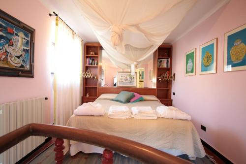 a bedroom with a bed with towels on it at Villa La Pietra - Luxury location in Levanto, 5 Terre in Levanto