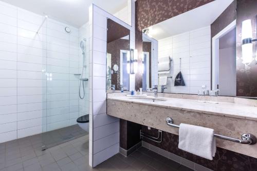 a bathroom with two sinks and a shower at Radisson Blu Hotel Malmö in Malmö