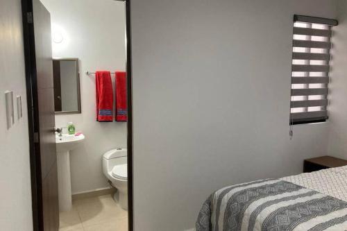 a bathroom with a bed and a toilet and a sink at Preciosa Enjoyable Casa 12 Personas Alberca Playa Coto 24H in Mazatlán