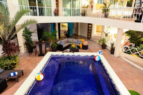 an indoor swimming pool in the middle of a house at Blue Chairs Beachfront Resort Puerto Vallarta - Adults Only in Puerto Vallarta