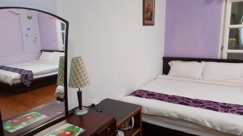 a small room with two beds and a mirror at Dongshan River Left Bank in Wujie