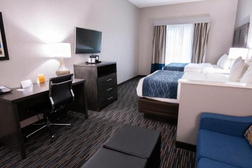 a hotel room with a bed and a desk at Comfort Inn & Suites Near Medical Center in San Antonio