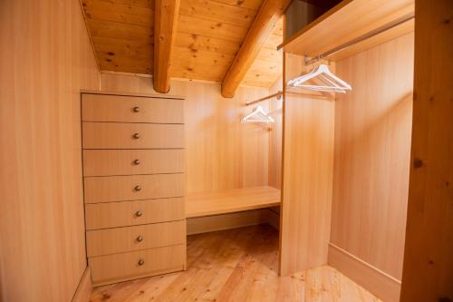 a walk in closet with wooden floors and wooden ceilings at Residenza Marconi in Pinzolo