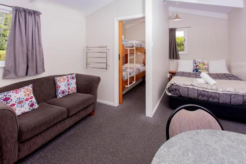 a living room with a couch and a bed at Hanmer Springs TOP 10 Holiday Park in Hanmer Springs