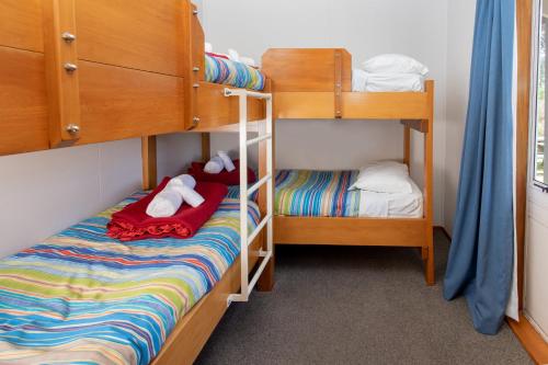 a bedroom with two bunk beds and a bed at Hanmer Springs TOP 10 Holiday Park in Hanmer Springs