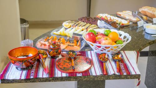 
a table topped with lots of different types of food at Hotel Petrov in Canela

