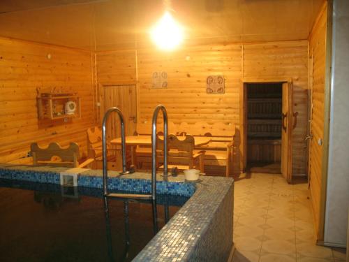 a bathroom with a swimming pool in a wooden cabin at Villa Ignatyeva in Skhidnitsa