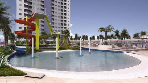 a pool with a slide in the middle of a resort at Apartamento em Salinas Exclusive Resort in Salinópolis