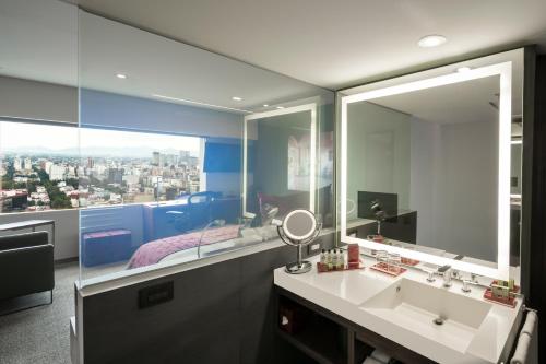 a bathroom with two sinks and a large mirror at InterContinental Presidente Mexico City, an IHG Hotel in Mexico City
