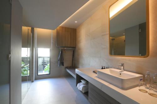 a bathroom with a sink and a mirror at The Signature Hotel Airport in Hat Yai