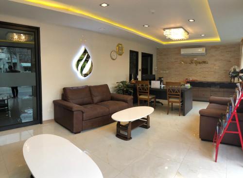 a living room with a couch and a table at Hotel De Sripoom in Chiang Mai