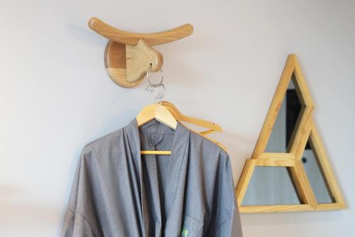 a cape hanging on a wall next to a wooden frame at The Signature Hotel Airport in Hat Yai