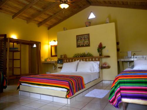 a bedroom with two beds in a room at Tranquility Bay Beach Retreat in Trujillo