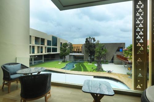 a view of the pool from the balcony of a building at The Signature Hotel Airport in Hat Yai
