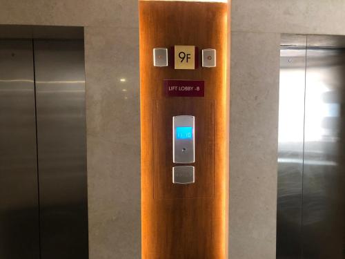 an elevator with an iphone on the door at Oakwood Residence Whitefield Bangalore in Bengaluru