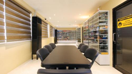 a conference room with a long table and chairs at RedDoorz at Hotel Rosemarie in Manila