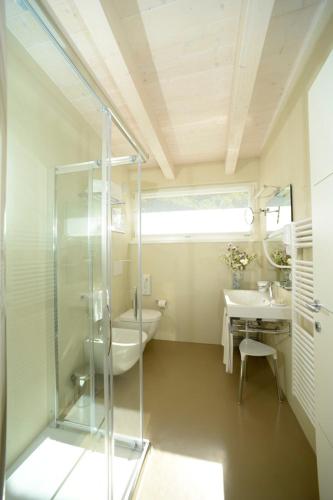 a bathroom with a glass shower and a sink at Agriturismo Maso Grener in Lavis