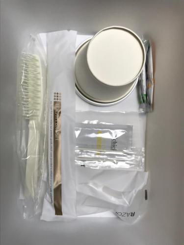a refrigerator with a bag of food and a plate at Bell's Inn Tsuchiura in Tsuchiura