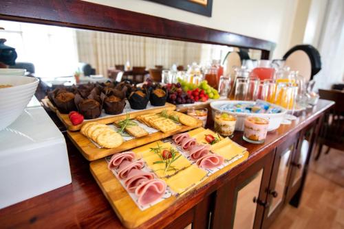 a buffet with different types of food on a table at New England Guest House by Ilawu in Pietermaritzburg