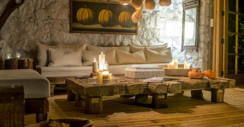 a living room with a couch and a table with candles at Nautical Hotel in Faralya