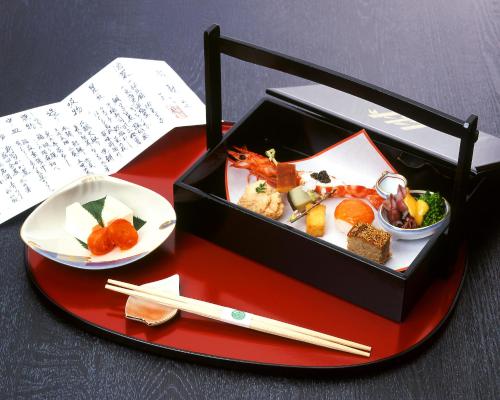a box of food on a table with a plate of food at Gyokutei in Hakone
