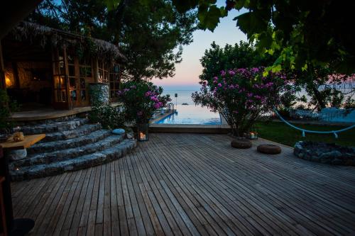 a view of the ocean from a resort with flowers at Nautical Hotel in Faralya