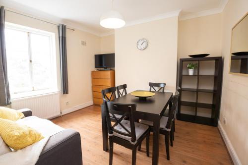 a living room with a table and chairs and a couch at Camden City Living in London