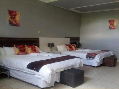 a hotel room with two beds in a room at Dam Vista Retreat in Giyani