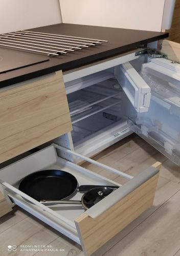 an open drawer with a frying pan in it at Apartmán Paula 2 in Podhájska